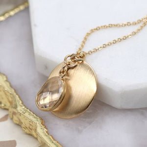 Golden brushed disc and clear crystal charm necklace